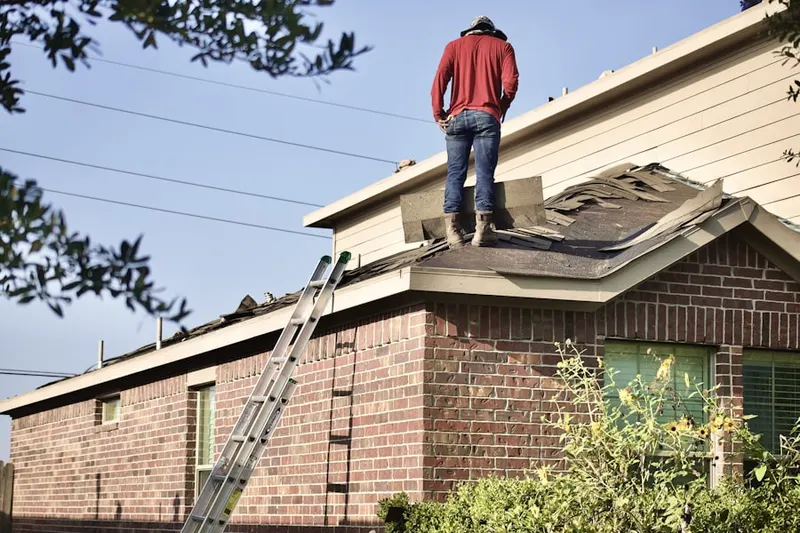 Professional roofer working on a residential roof in West Spring Mills